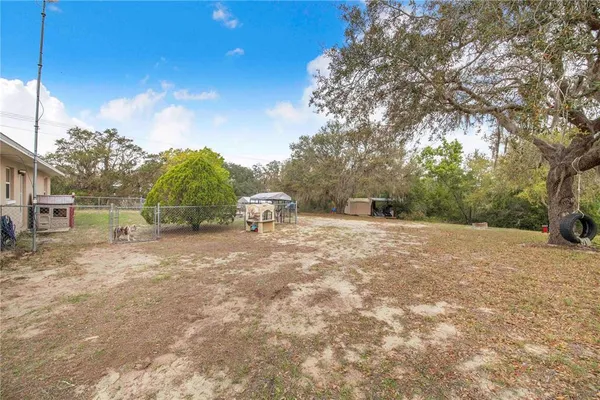 a backyard of a house with large trees