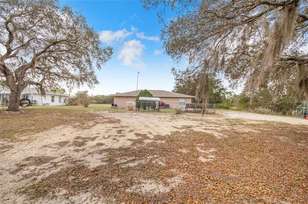 a view of a house with a tree and a yard