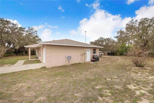 a view of a house with a backyard
