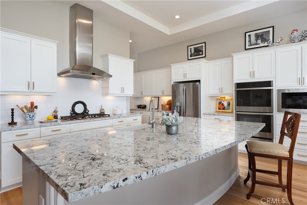 1650 Eucalyptus Road Nipomo, CA 93444 - Photo 12 of 60 a kitchen with stainless steel appliances granite countertop a sink dishwasher and cabinets with wooden floor