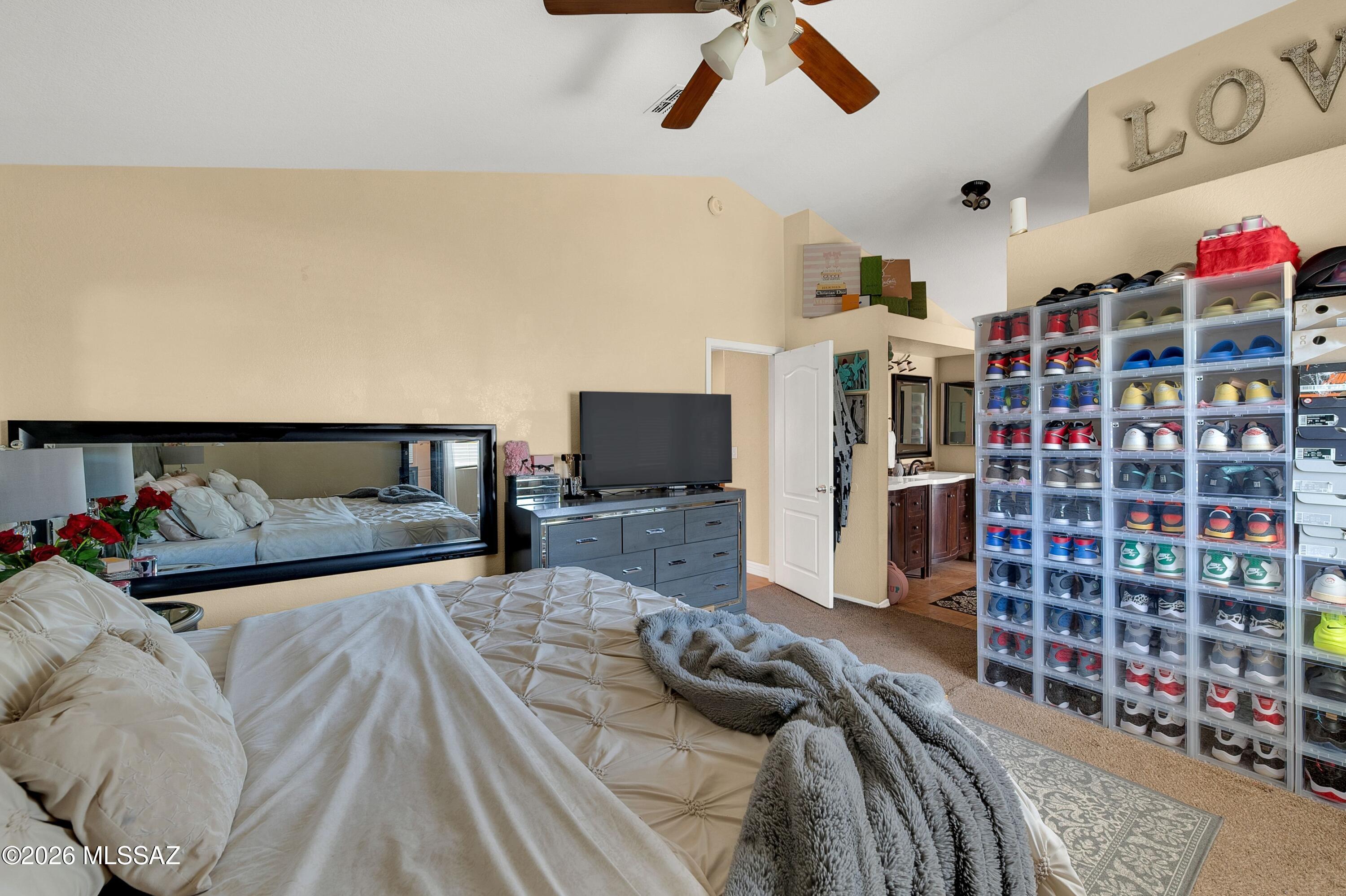 7159 West Maple Ridge Drive Tucson, AZ 85743 - Photo 21 of 42 a bedroom with a bed and a bookshelf