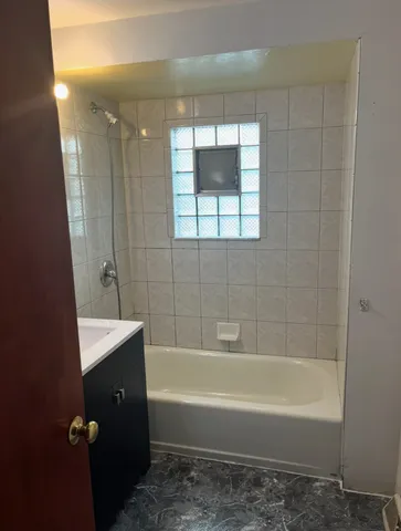 a bathroom with a bathtub a shower a sink and vanity