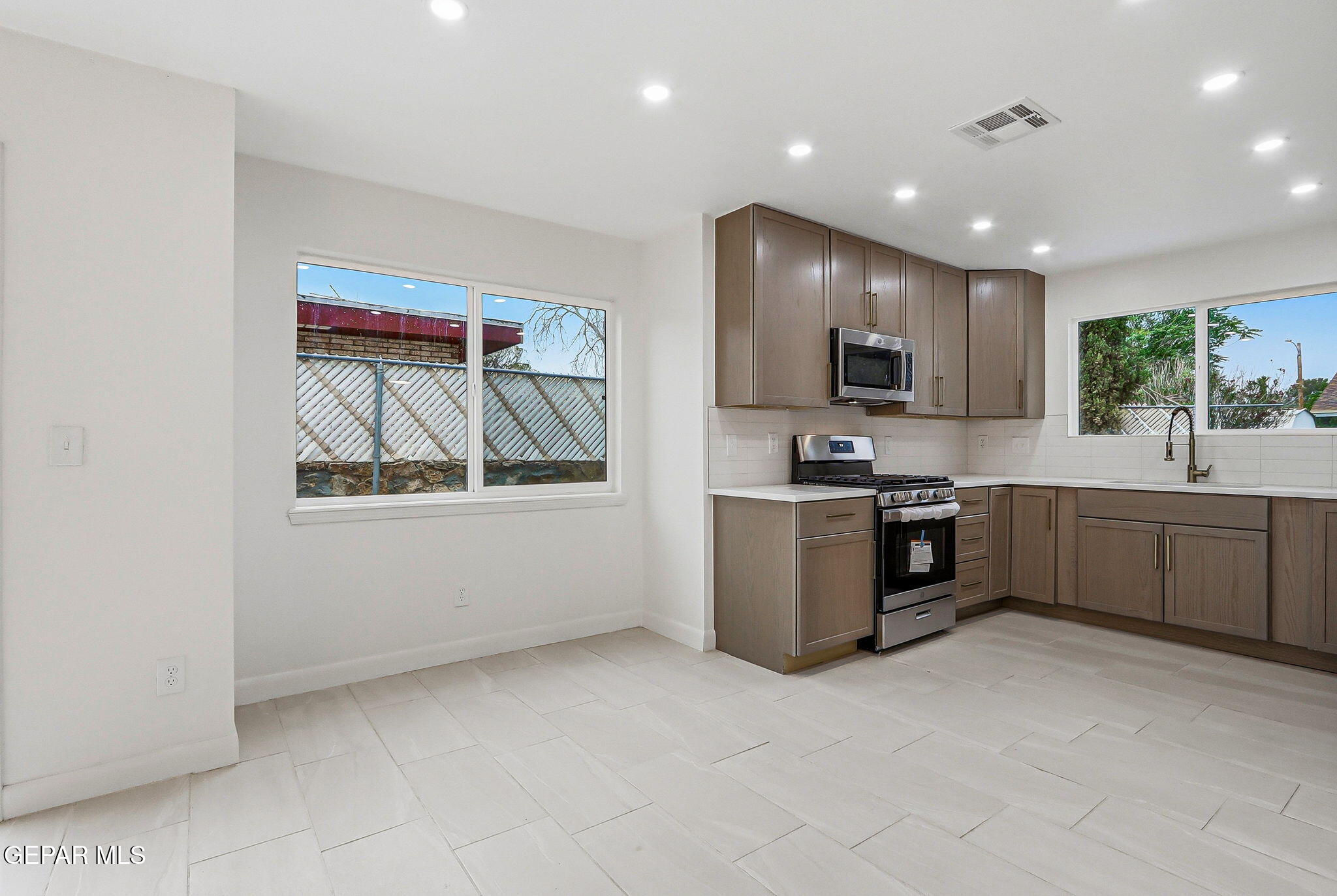 709 Frontera Road El Paso, TX 79922 - Photo 11 of 41 a kitchen with stainless steel appliances granite countertop a stove a sink and a refrigerator