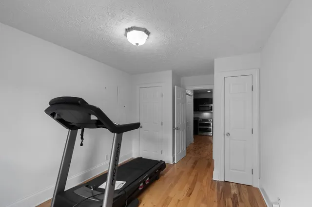 a view of a room with wooden floor and closet