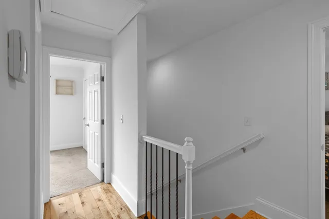 a view of hallway with wooden floor