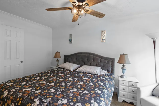 a bedroom with a bed and a chandelier