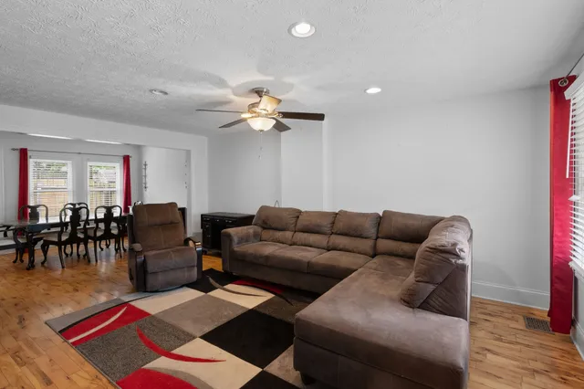 a living room with furniture a dining table and with rug