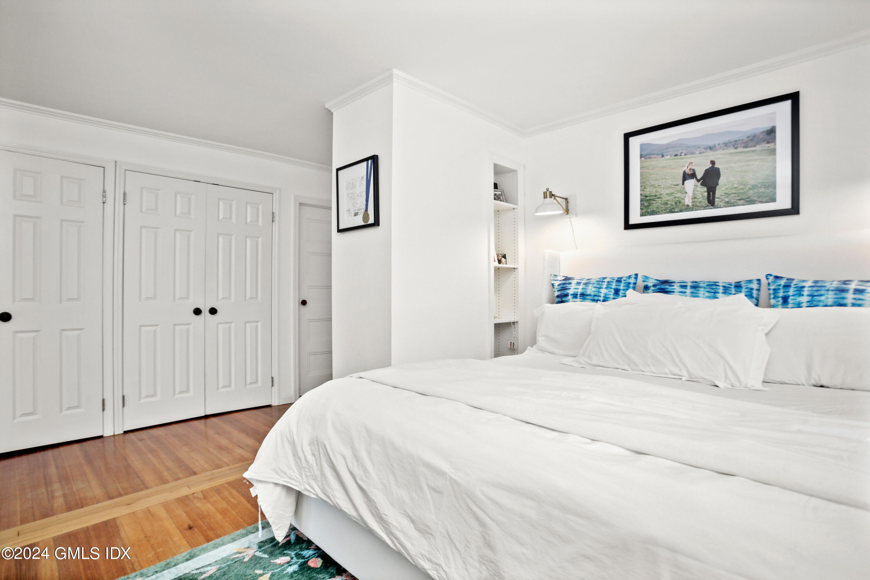 18 Shore Road Old Greenwich, CT 06870 - Photo 15 of 51 a bedroom with a bed and a painting on the wall