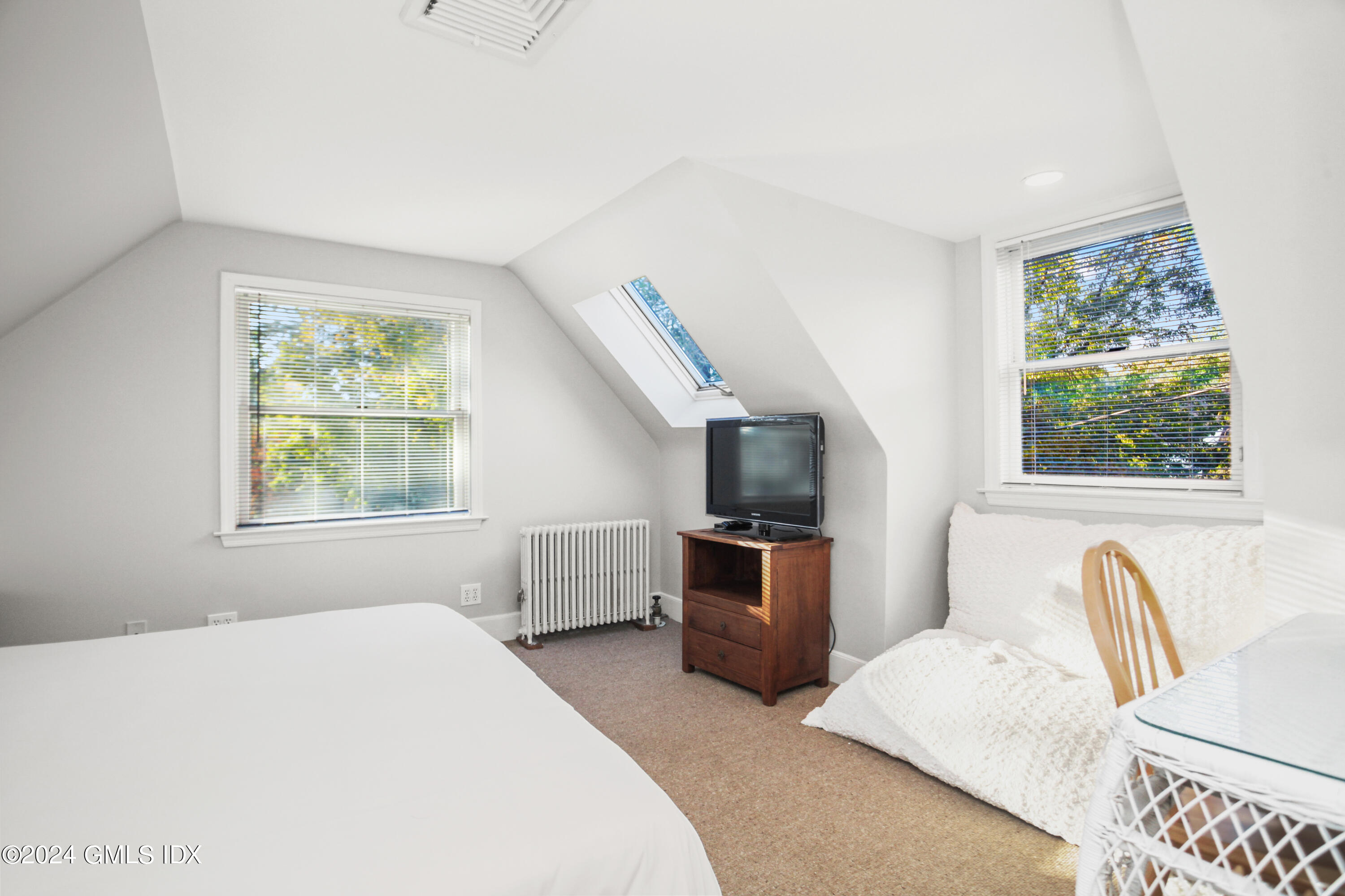 18 Shore Road Old Greenwich, CT 06870 - Photo 20 of 51 a bedroom with a large bed and a flat tv screen on dresser