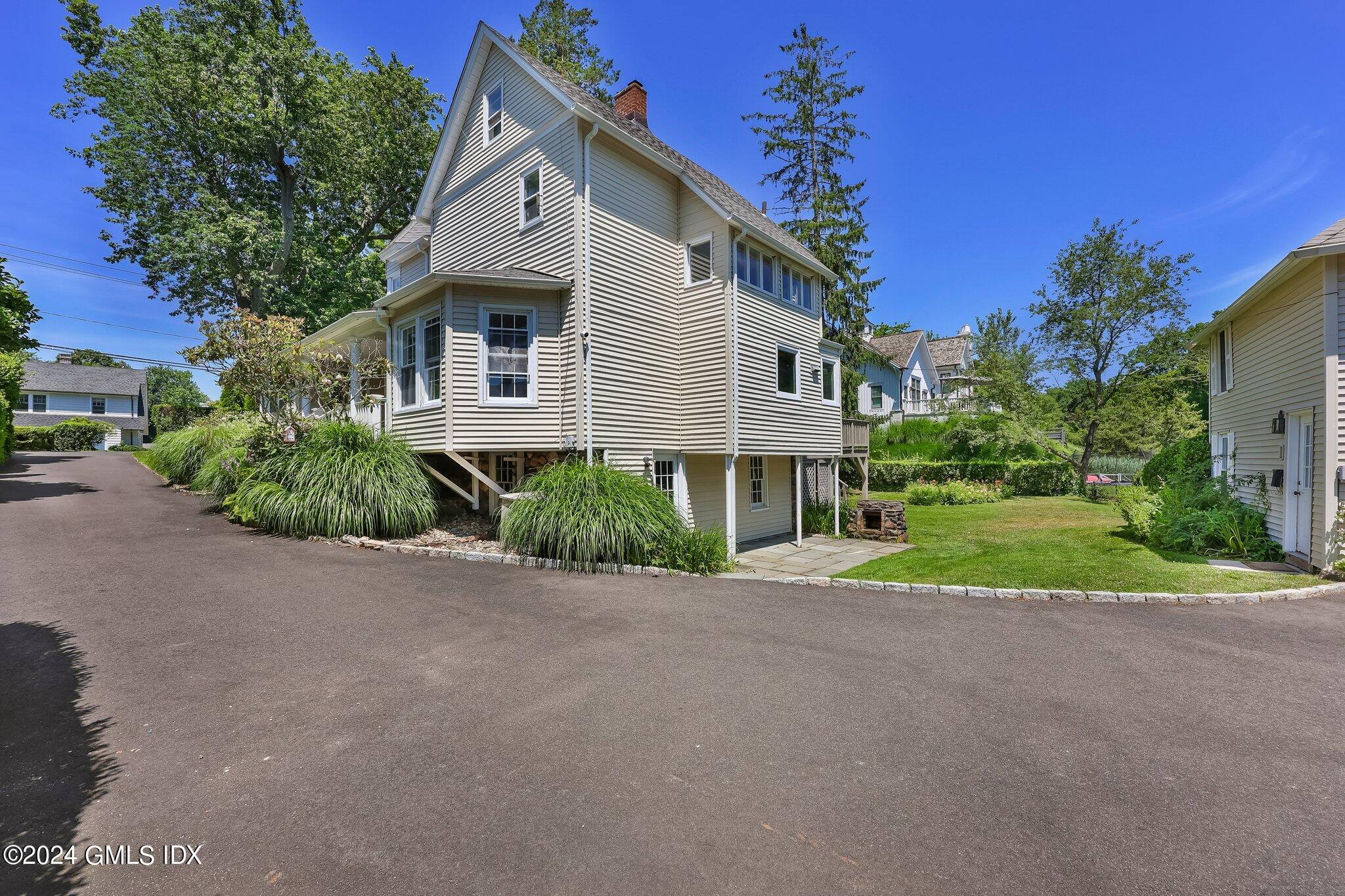 18 Shore Road Old Greenwich, CT 06870 - Photo 27 of 51 a front view of house with yard and green space