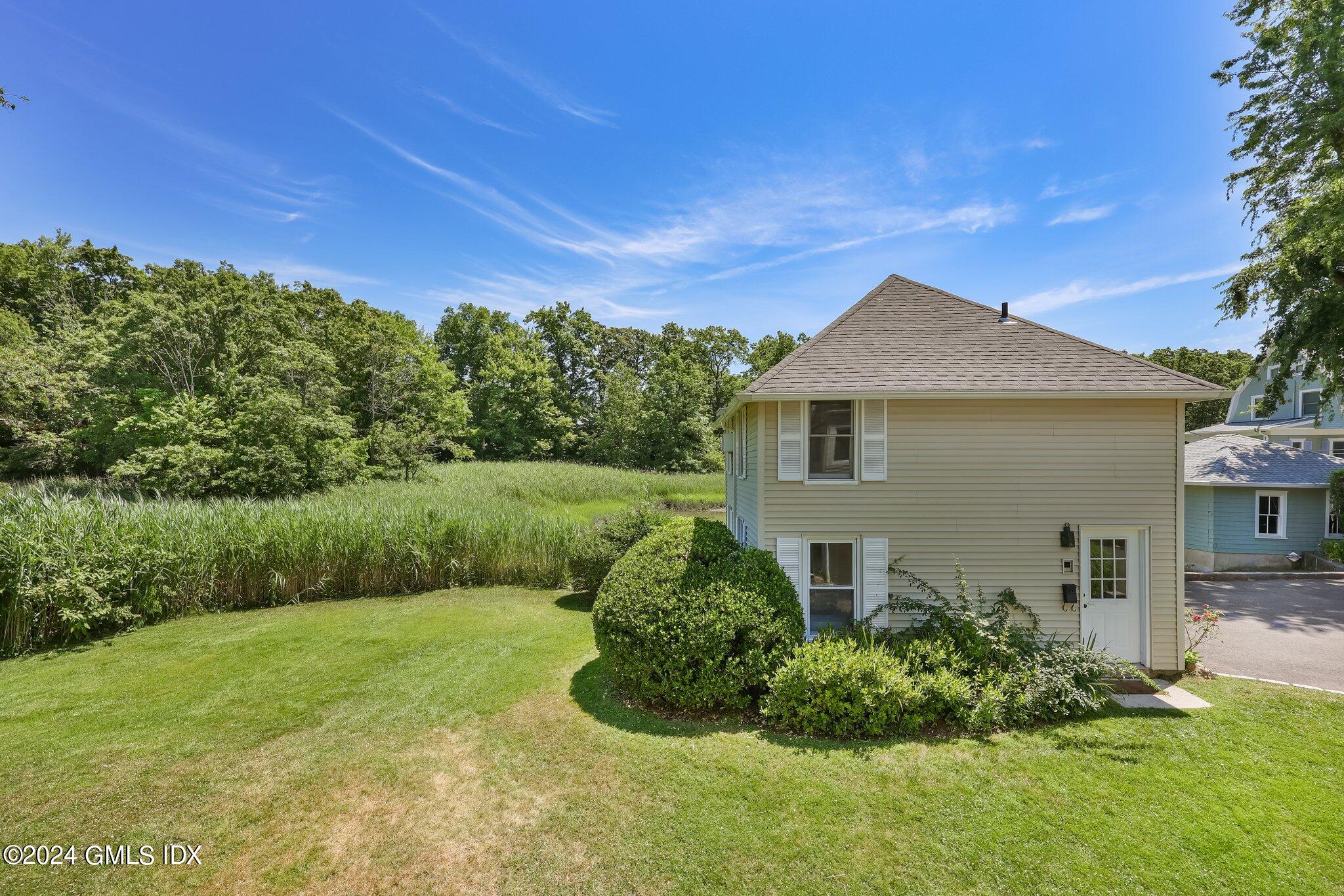 18 Shore Road Old Greenwich, CT 06870 - Photo 36 of 51 a front view of a house with a yard