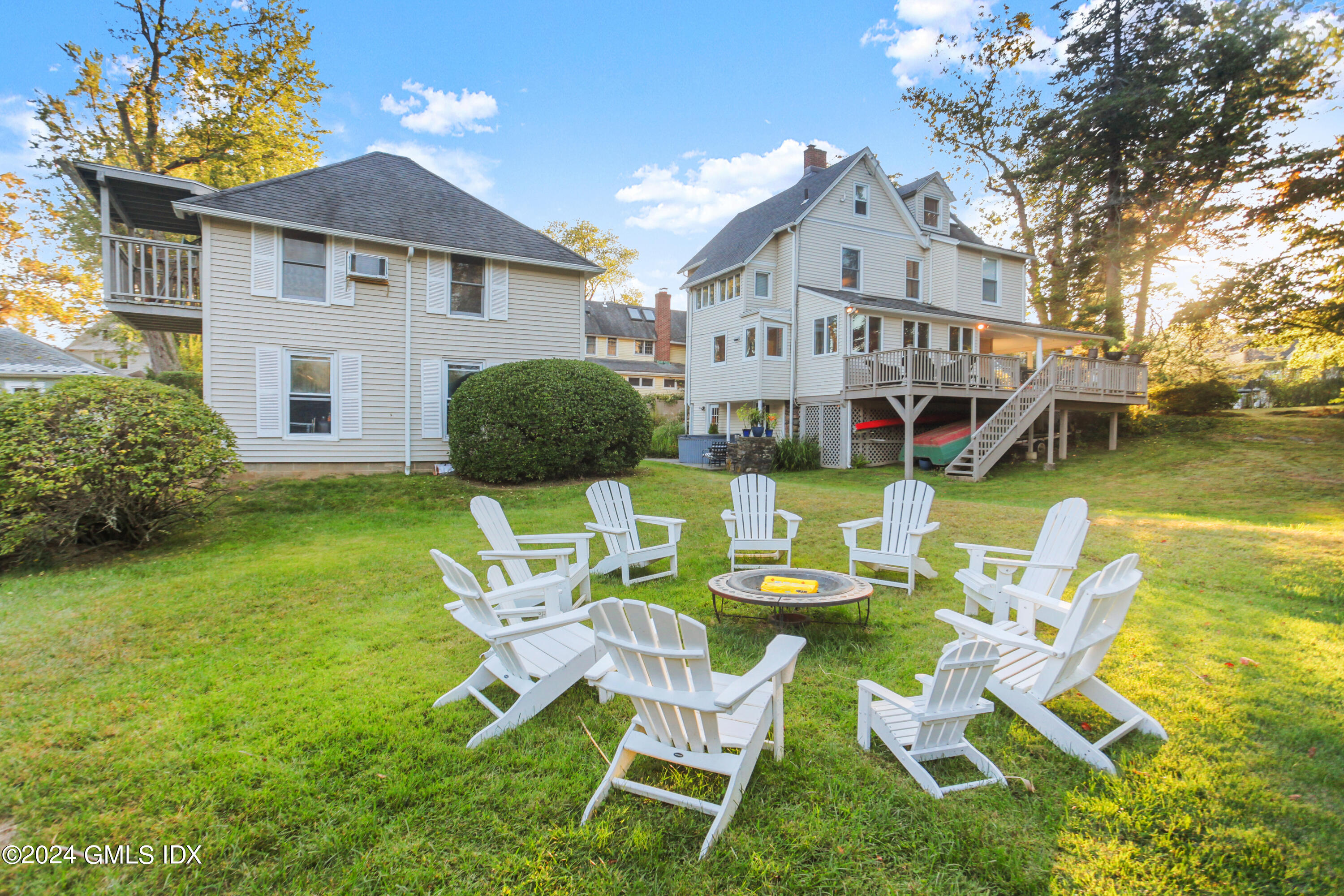 18 Shore Road Old Greenwich, CT 06870 - Photo 37 of 51 a view of a chairs and table in backyard of the house