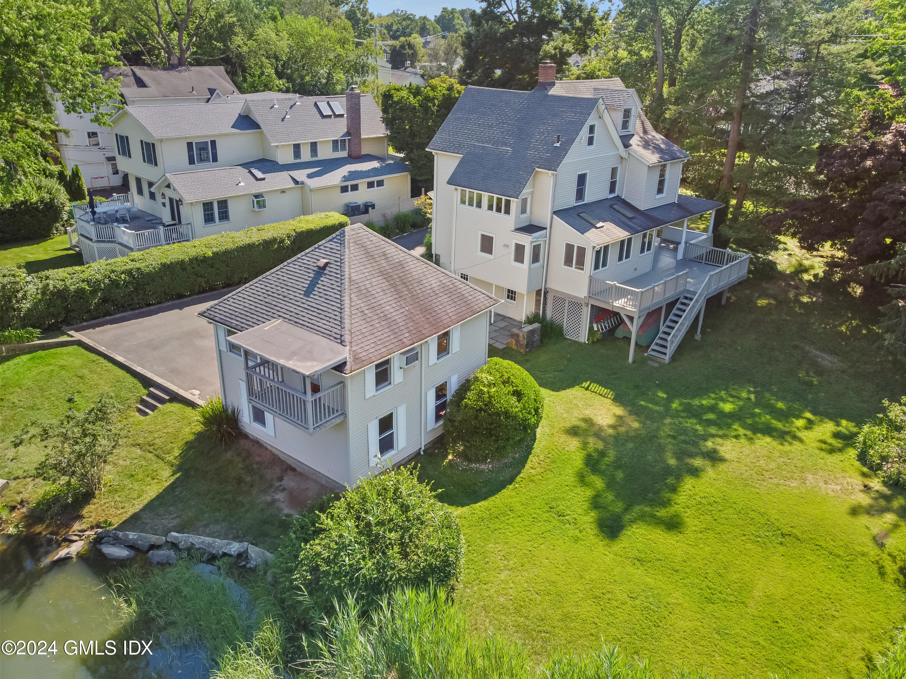 18 Shore Road Old Greenwich, CT 06870 - Photo 39 of 51 an aerial view of a house with a garden and swimming pool