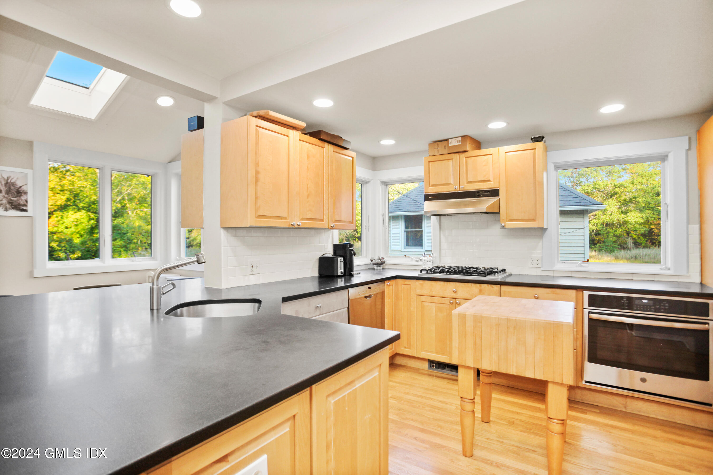 18 Shore Road Old Greenwich, CT 06870 - Photo 7 of 51 a kitchen with a sink appliances cabinets and a large window