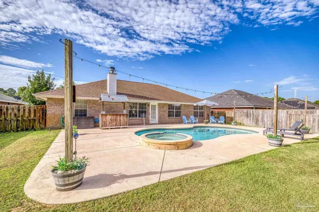 a view of a backyard with sitting area