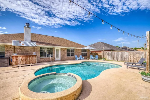 a view of a patio with a table chairs and a backyard