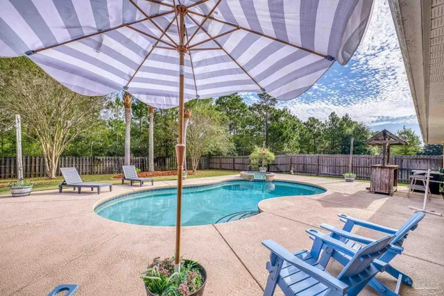 a view of a house with a yard and sitting area
