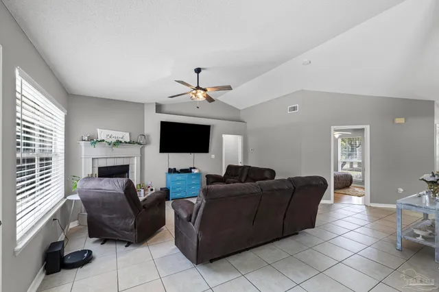 a large kitchen with stainless steel appliances a stove a sink dishwasher a dining table and chairs with wooden floor