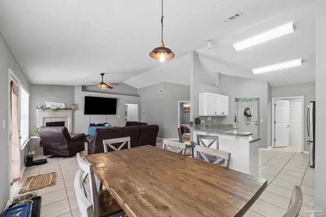 a kitchen with granite countertop a sink stove and refrigerator