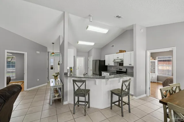 a kitchen with a stove sink and cabinets