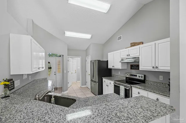 a kitchen with a refrigerator sink and stove