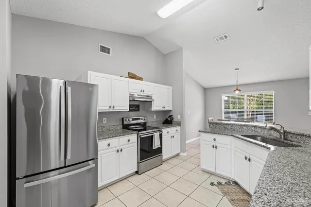 a bedroom with a bed and painting on the wall
