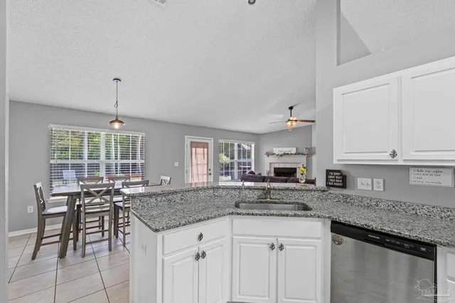 a spacious bathroom with a granite countertop sink mirror and bathtub