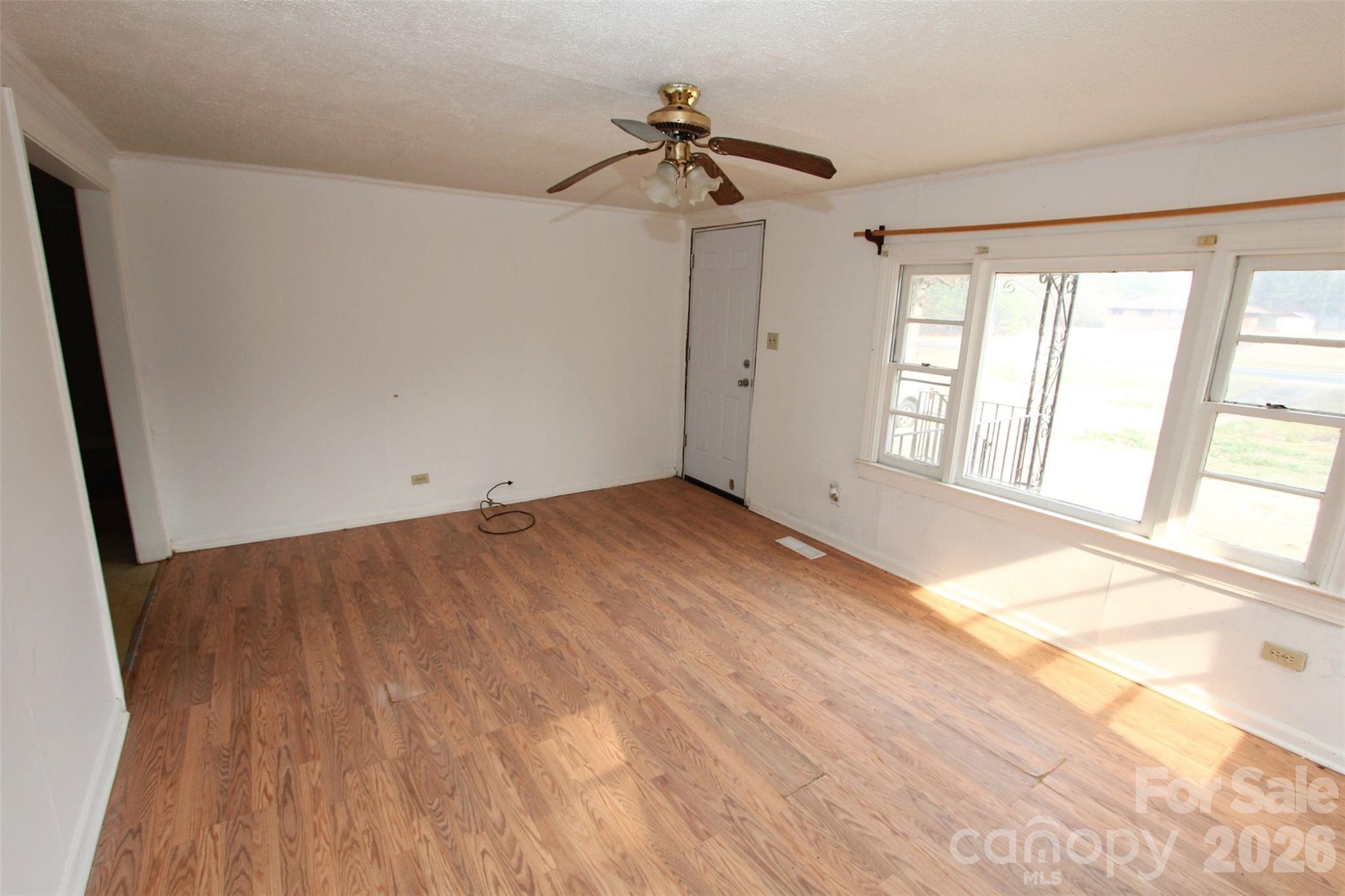 562 Us Highway South Rockingham, NC 28379 - Photo 15 of 42 a view of empty room with wooden floor and fan