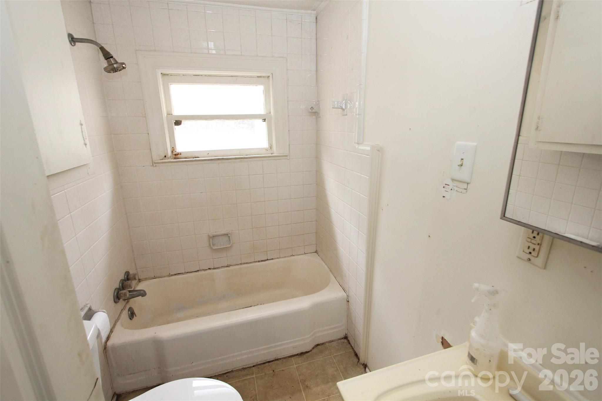 562 Us Highway South Rockingham, NC 28379 - Photo 16 of 42 a bathroom with a bathtub and shower