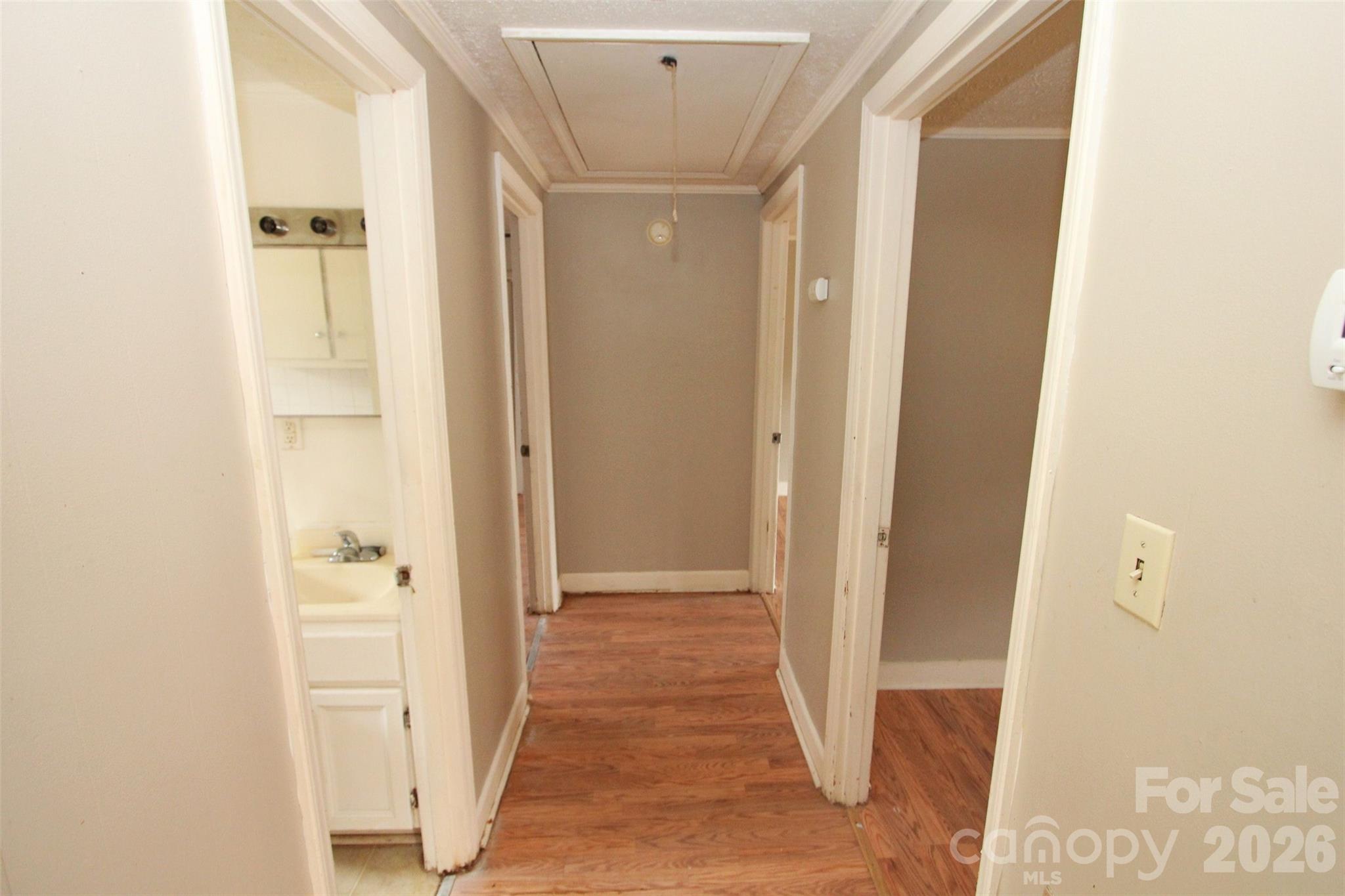 562 Us Highway South Rockingham, NC 28379 - Photo 20 of 42 a view of a hallway with wooden floor and a bathroom