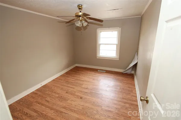 a view of an empty room with a ceiling fan