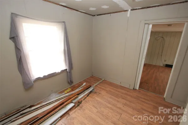 a view of room with wooden floor
