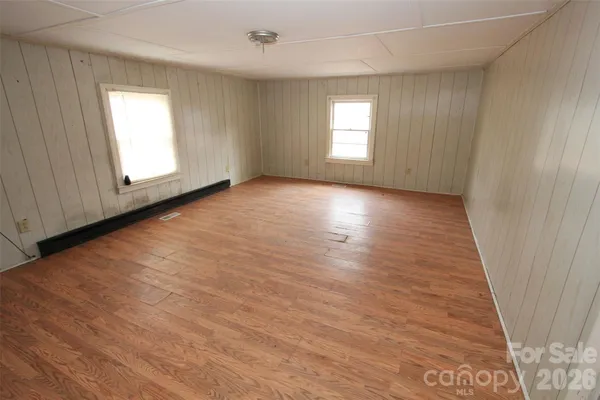 a view of an empty room with wooden floor