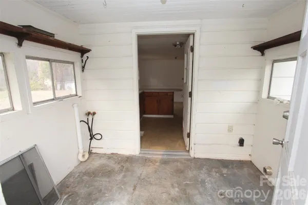 a view of a storage and utility room with furniture and a window