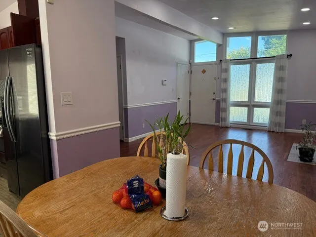 a view of a dining room with furniture and a potted plant