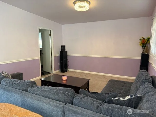 a living room with a couch and a potted plant