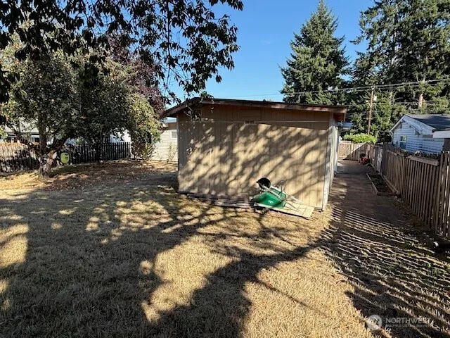 a view of a yard with plants and trees