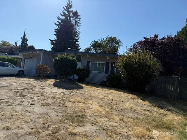 a backyard of a house with table and chairs