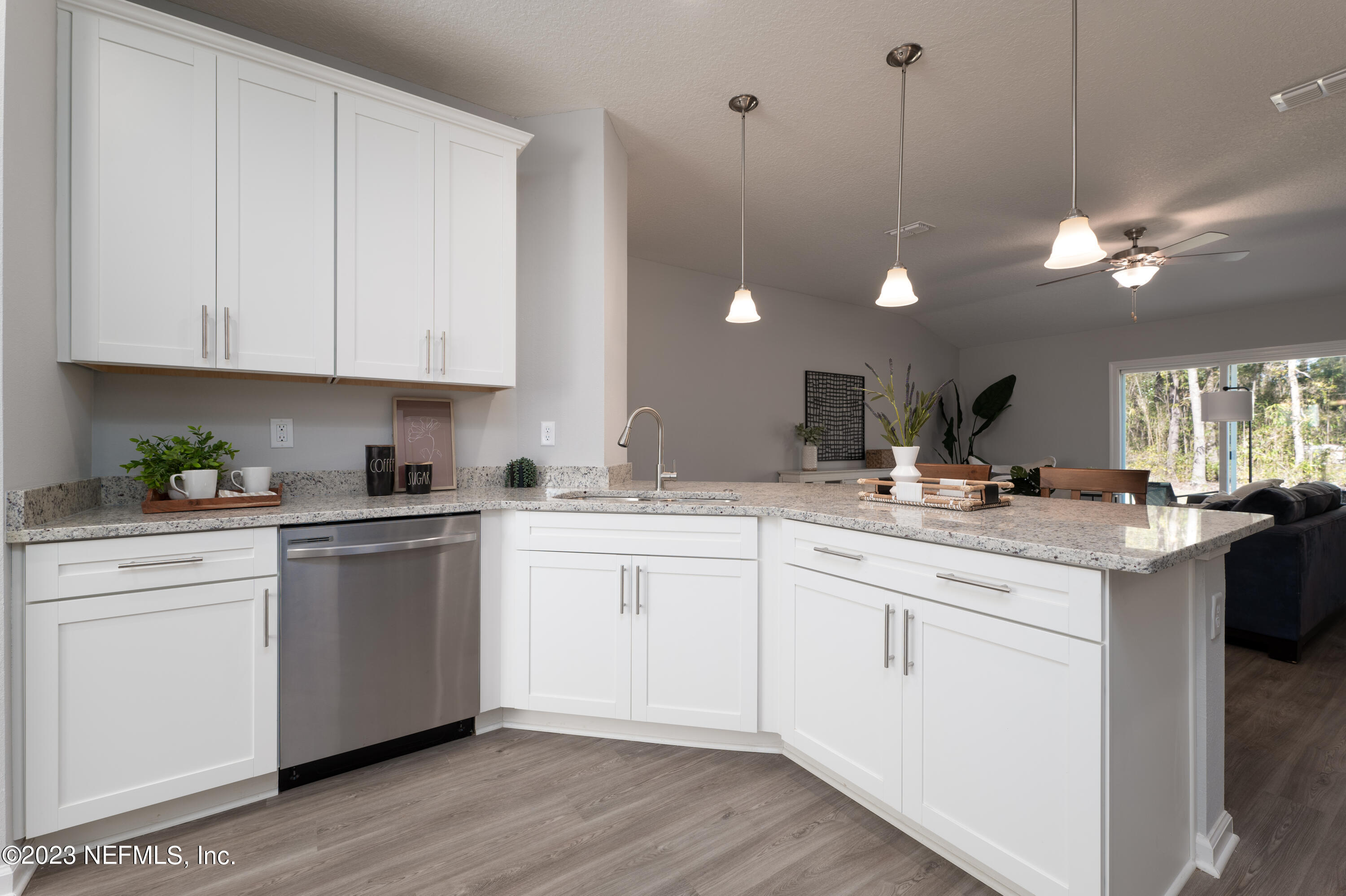12701 Dunn Creek Road Jacksonville, FL 32226 - Photo 13 of 51 a kitchen with a sink cabinets and wooden floor