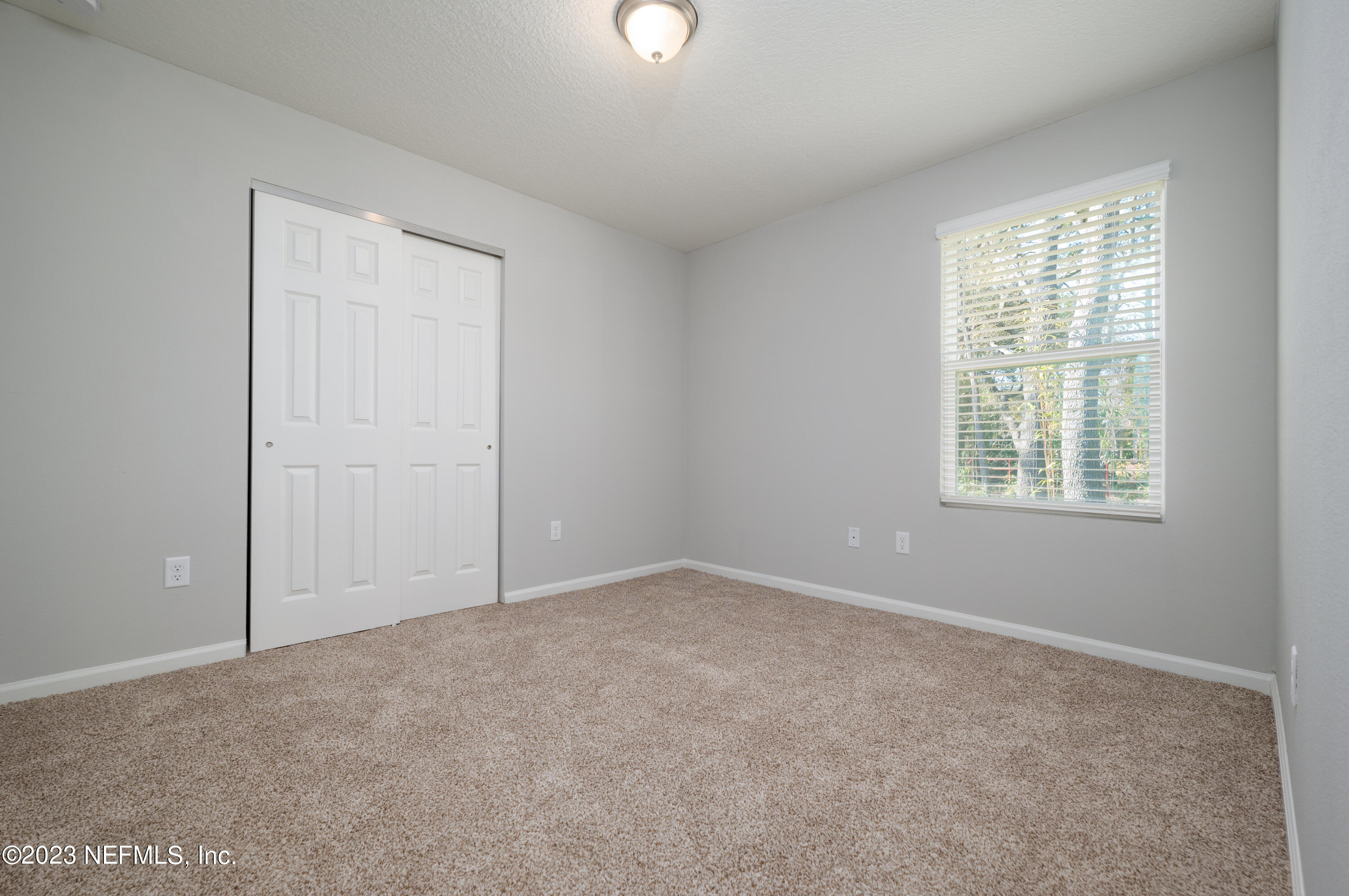 12701 Dunn Creek Road Jacksonville, FL 32226 - Photo 18 of 51 an empty room with windows and closet