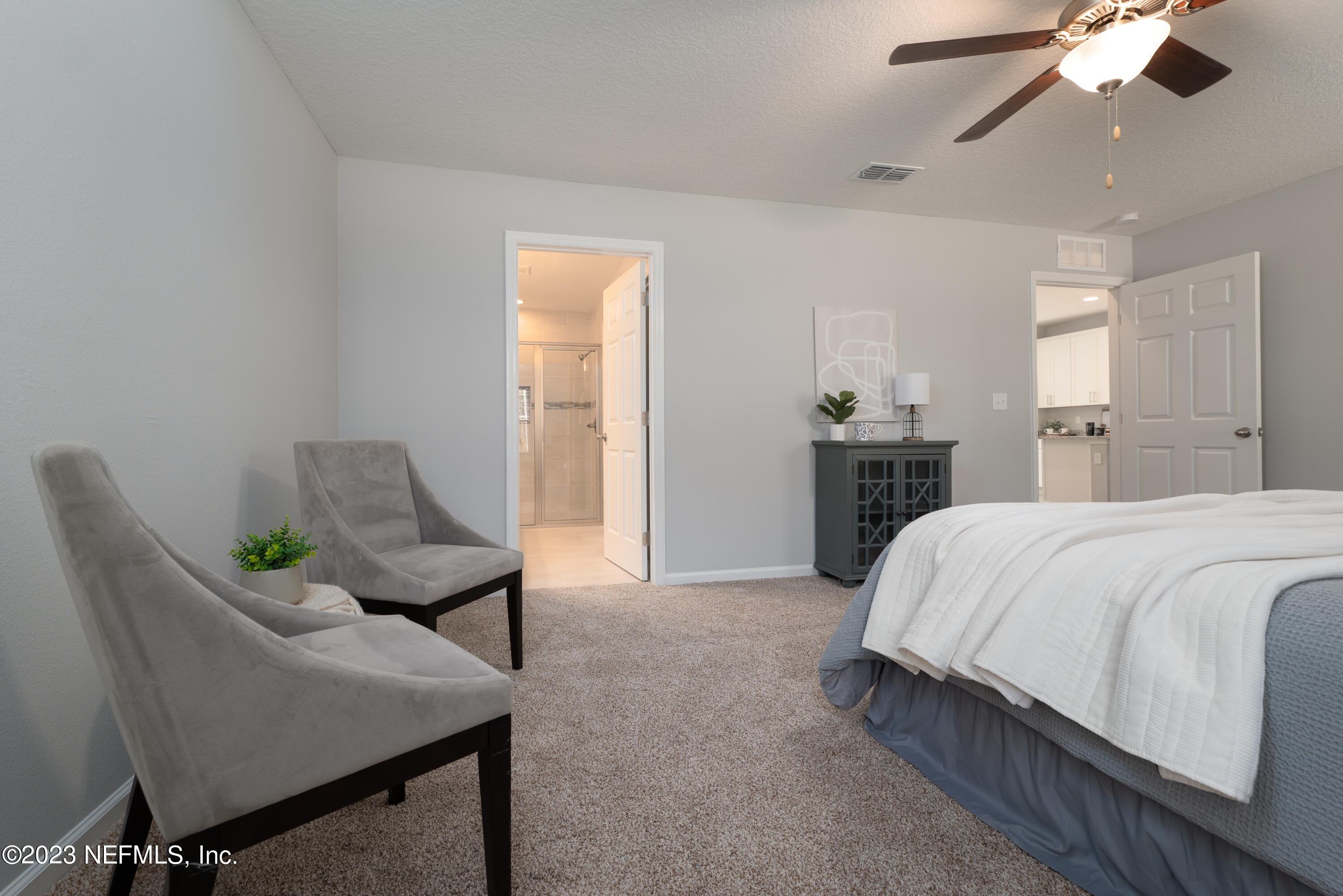 12701 Dunn Creek Road Jacksonville, FL 32226 - Photo 25 of 51 a spacious bedroom with a bed and chair