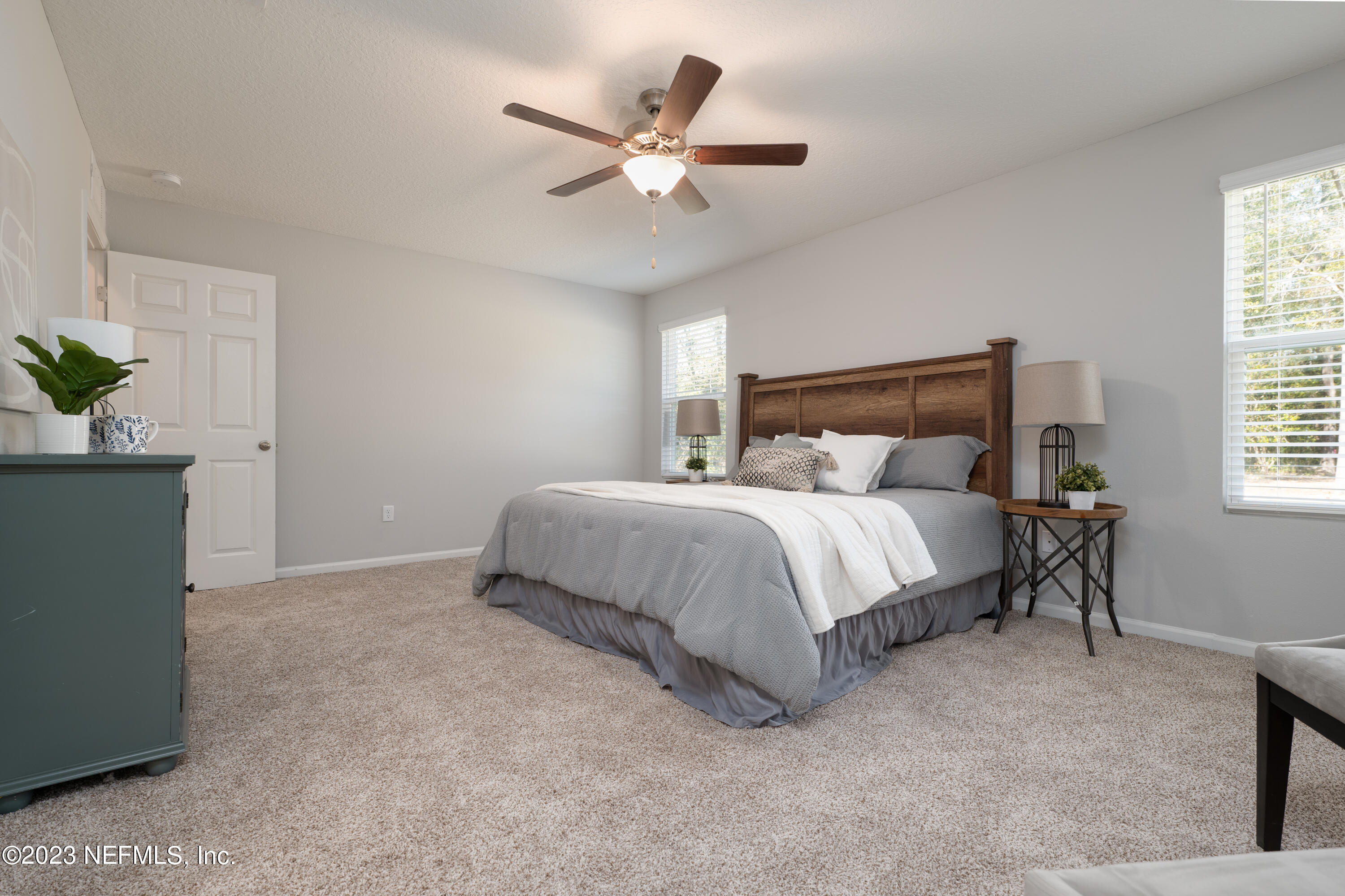 12701 Dunn Creek Road Jacksonville, FL 32226 - Photo 28 of 51 a bedroom with a bed and a potted plant