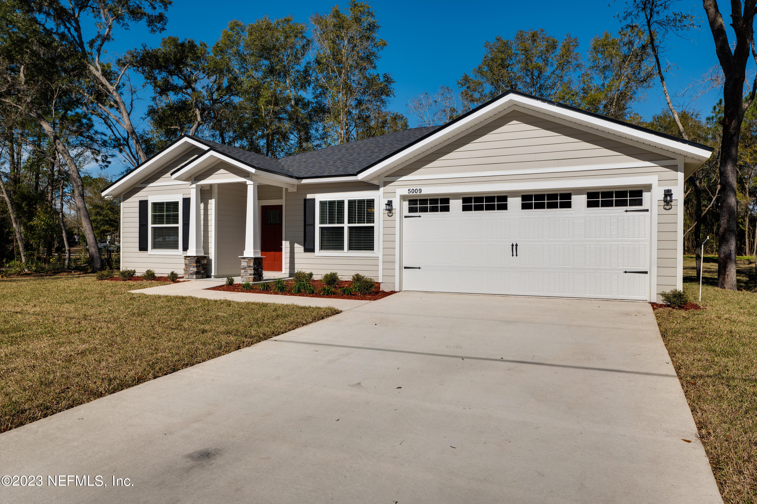 12701 Dunn Creek Road Jacksonville, FL 32226 - Photo 51 of 51 a front view of a house with a yard and trees