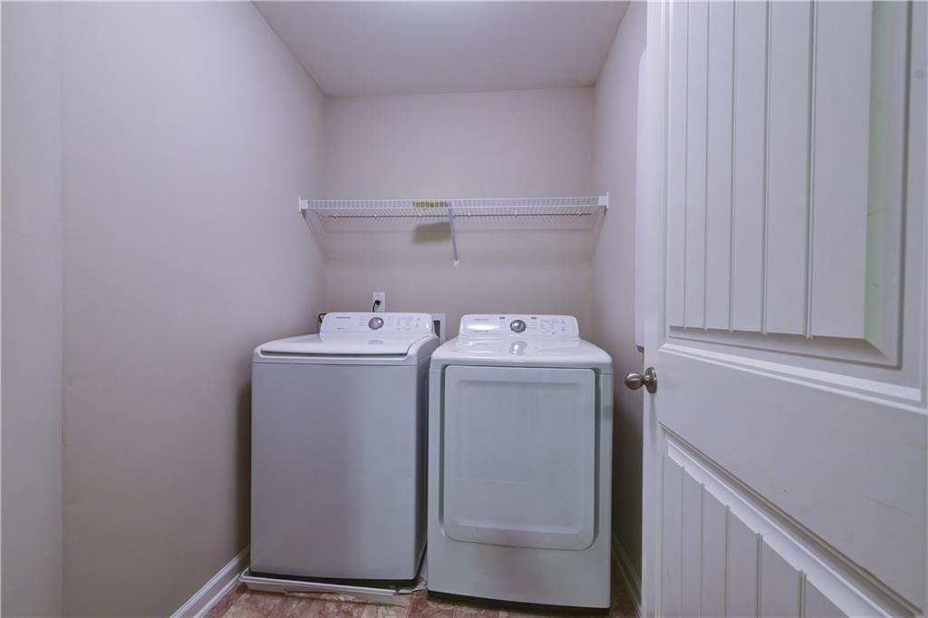 1226 Fischer Trace Cumming, GA 30041 - Photo 22 of 24 a utility room with dryer and washer