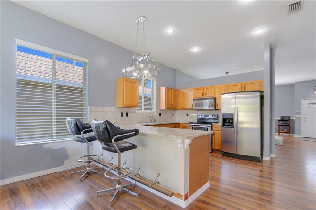 2539 Southeast Springtree Place Stuart, FL 34997 - Photo 11 of 20 a kitchen with refrigerator cabinets and wooden floor