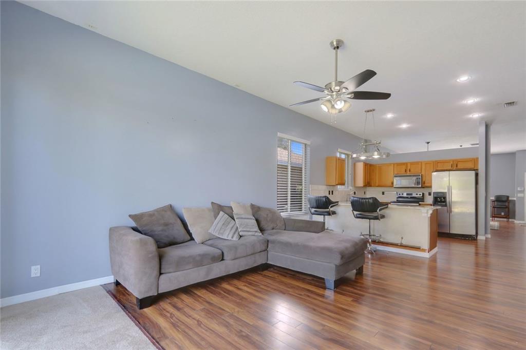 2539 Southeast Springtree Place Stuart, FL 34997 - Photo 14 of 20 a living room with furniture kitchen view and a chandelier