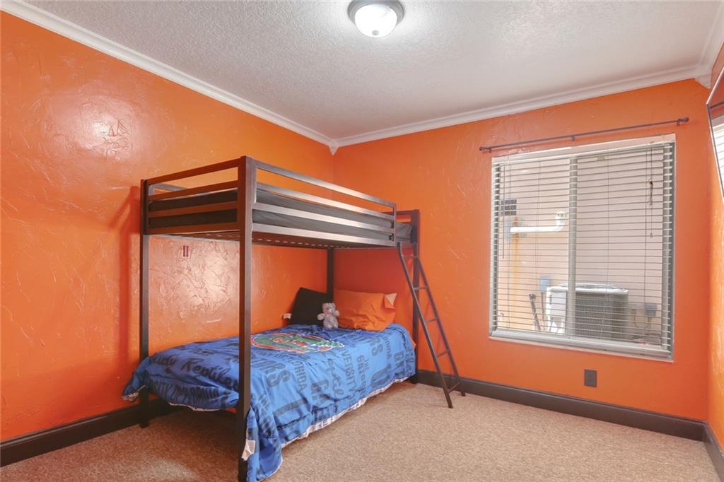 2539 Southeast Springtree Place Stuart, FL 34997 - Photo 18 of 20 a bedroom with a bed and a window