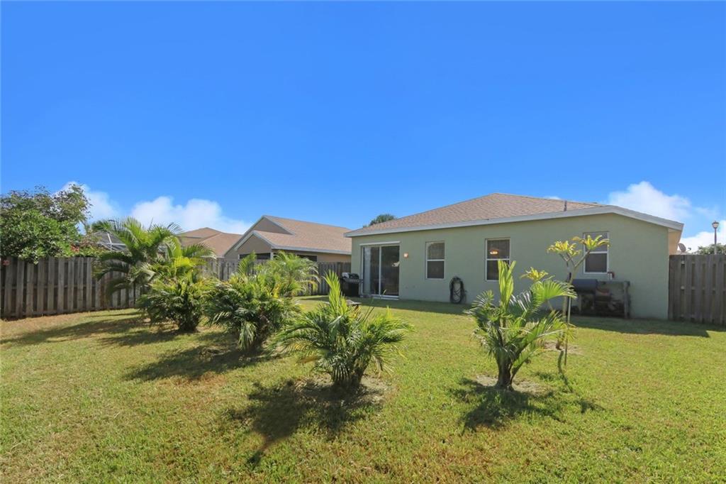 2539 Southeast Springtree Place Stuart, FL 34997 - Photo 9 of 20 a house view with swimming pool in front of it