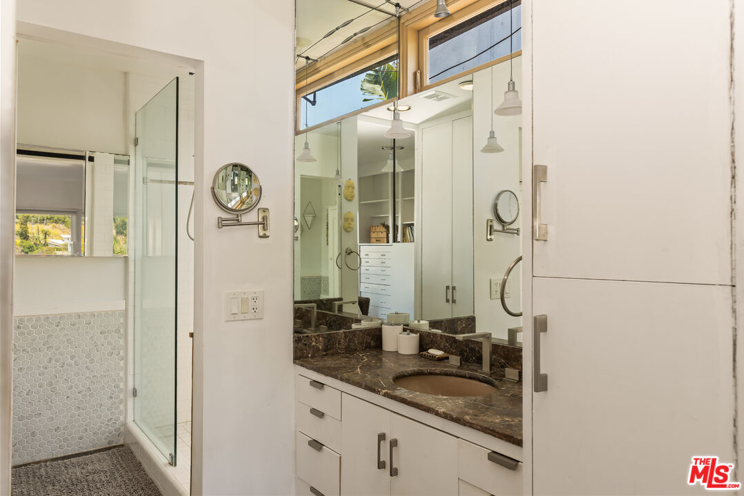 454 Stassi Lane Santa Monica, CA 90402 - Photo 14 of 33 a bathroom with a granite countertop sink and a mirror