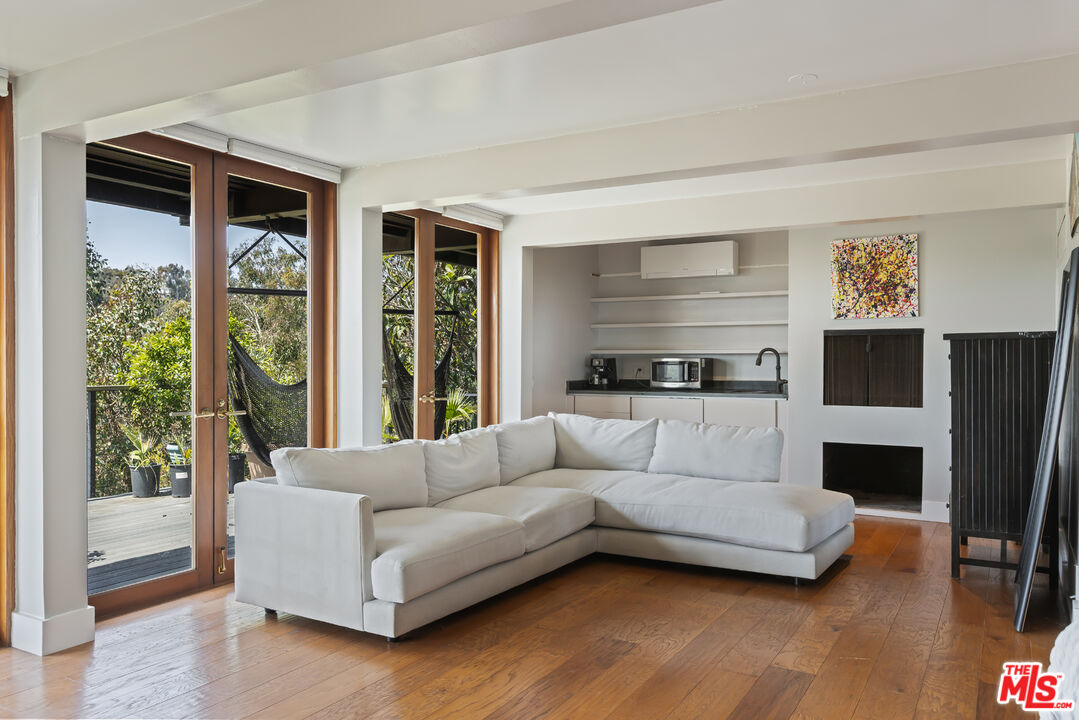 454 Stassi Lane Santa Monica, CA 90402 - Photo 16 of 33 a living room with furniture and a large window
